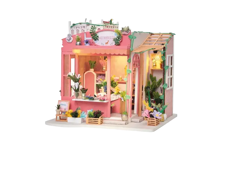 Maquette détaillée d'une petite boutique de fleurs colorée avec des plantes, des fleurs en pot et des décorations végétales sur un socle blanc.

Description générée par IA
