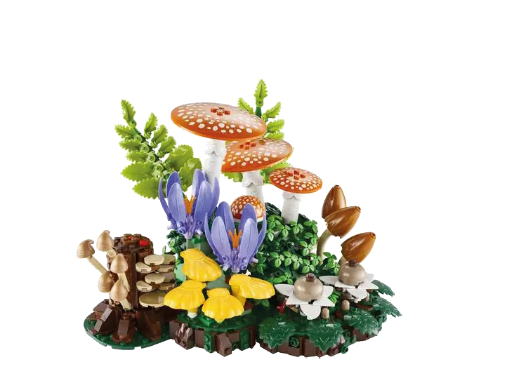 Une scène miniature en LEGO représentant un sous-bois avec des champignons orange à pois blancs, des fleurs violettes, des feuilles vertes et des champignons jaunes.

Description générée par IA